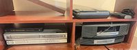 Overall view showing Magnavox deck, Arris box, Bose unit in wood cabinet