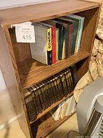 Front view of brown oak veneer bookshelf with three shelves