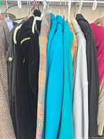 Row of assorted coats and jackets on hangers
