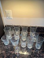 Group view of all 13 clear glass pieces on countertop