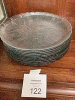 Stack of eight clear glass floral embossed plates