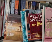 Shelf view showing multiple paperback spines and front covers including What Does God Expect of a Man? and Welcome Speeches and More
