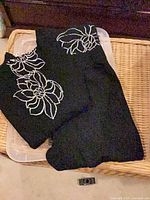 Black pants with white floral embroidery