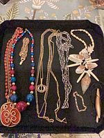 group view of all jewelry pieces on black tray
