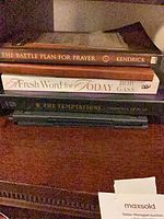 Stack of three hardcover books showing titles and authors