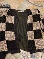 Front of black and silver sequin tweed patchwork jacket