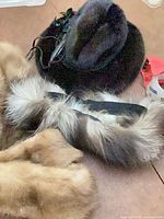 Dark brown fur hat, fox fur collar, partial view of mink stole