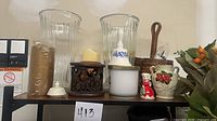 Shelf with glass vases, candles, ceramics, wicker holder
