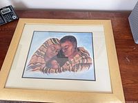 Full view of framed family print on tabletop
