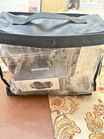 Clear carry bag showing boxed Garmin GPS and accessories