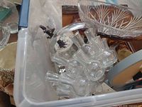 overview showing glass flower frog cluster, cut glass bowl, ceramic pot rim, partial mantle clock and wood plaque