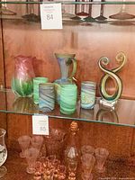 Shelf view showing vase, four tumblers, pitcher and figure-eight sculpture