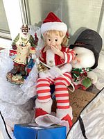 Plush elf, snowman, resin Santa grouped together in bag