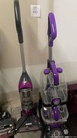 Hoover carpet washer and Shark vacuum standing side by side
