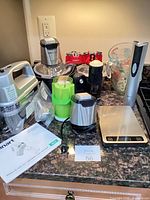 Overall view showing hand mixer, chopper, grinder, scale and measuring cup