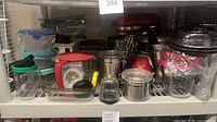Shelf view with mixer, blender parts, pots, containers