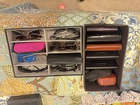 Two organiser boxes showing assorted eyewear and cases