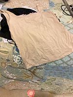 Beige camisole laid flat on bed