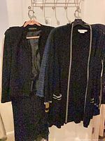Front view of grouped jackets and cardigans on hangers