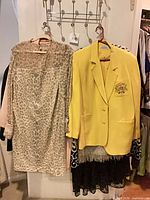 Leopard print jacket and yellow blazer hanging on rack
