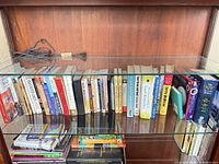 Overview of two shelves showing entire lot of approximately 40 assorted books