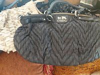 Coach black ruched handbag close-up