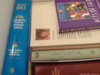 Stack showing Bible spine and several book titles