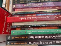 Stacked paperbacks showing spines with visible titles such as Victory Over the Darkness and The Power of a Praying Wife