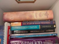 Stacked view of several sermon and preaching books showing spines