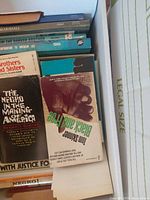 Books in box showing covers of Black and Free, The Negro in the Making of America, Brothers and Sisters and additional titles.