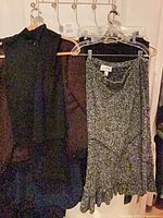 Group of jackets and skirts on hanger showing fabric textures