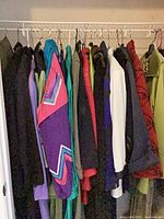 Row of assorted coats and jackets on hangers