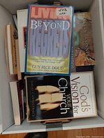 Top view of box showing multiple paperback books including Beyond Regrets and God’s Vision for Your Church