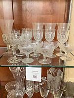 Overview of assorted stemware on glass shelf