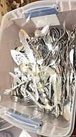 Top view of tote showing large quantity of mixed flatware pieces