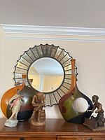 Overall view showing mirror (not included), both abstract painted wooden bottle sculptures, porcelain figurine, wooden thinker, and kneeling drummer
