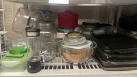 Shelf view showing entire assortment of bakeware, bowls, jars and containers