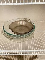 Stack showing smoked brown plate on top of clear glass plates
