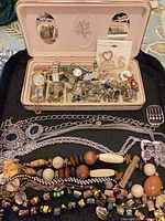 Overview of jewelry case, watches, necklaces, bracelets, brooches