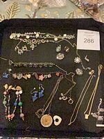 Overview of all jewellery items laid out on black tray