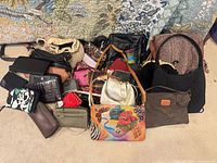 Wide shot of all handbags, wallets and pouches on floor