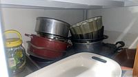 Overall lot showing stacked cookware, bakeware and jar
