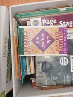 Top view of box showing mixed books including green “Black Americans” series, leader guide, and children’s titles