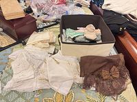 overview of lace and fabric pieces with bonnet and storage bin