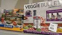 Boxed NutriBullet Veggie Bullet and Snapware sets side by side