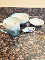 Group view of mug, bowl, saucer and spoon rest