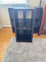 Three black cube shelf units arranged together