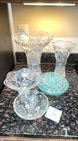 Group view of all five glass pieces on countertop