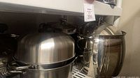 Multiple stainless steel pots, domed steamer, large stockpot