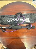 Summers GYMMAG bar, purple tube, black carry bag on table